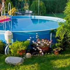 Small soft-sided above ground swimming pool in a small yard