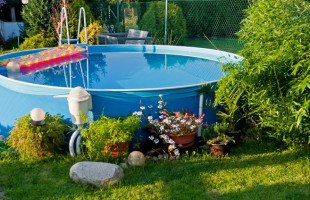 Small soft-sided above ground swimming pool in a small yard