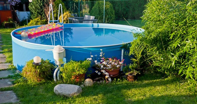 Small soft-sided above ground swimming pool in a small yard